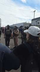 Police in tactical gear face protesters outside Newark prison