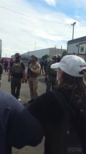 Police in tactical gear face protesters outside Newark prison