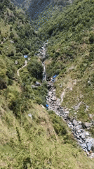 Woman plays with puppy in scenic Bhagsu valley