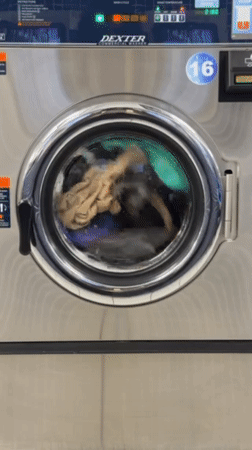 Commercial washing machine operates with colorful clothes in New York
