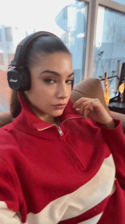 Woman in headphones sits by window in Moscow