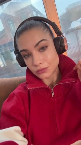 Woman in headphones sits by window in Moscow