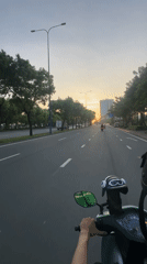 Evening traffic flows through Thủ Đức during vibrant sunset