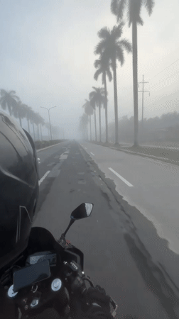 Heavy fog rolls over wet Tagum City roads at night