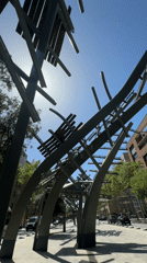 Visitor documents architecture and sculpture at Barcelona's Ciutadella Park