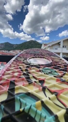 Skateboard, stormy skies, and Budva's mountain backdrop