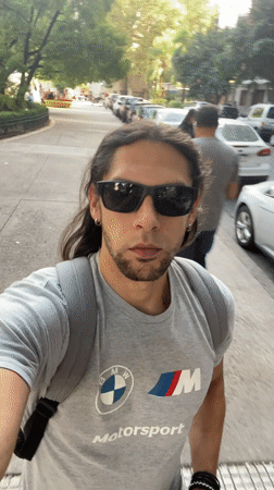 Man drinks beer while walking Buenos Aires street