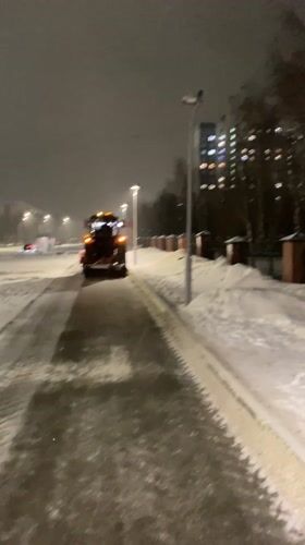 Snow removal vehicle operates on Nizhnevartovsk street at night
