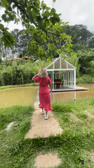 Woman in red dress explores scenic Da Lat with pets