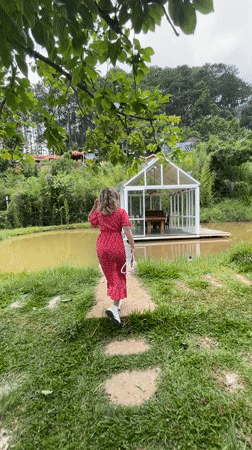 Woman in red dress explores scenic Da Lat with pets