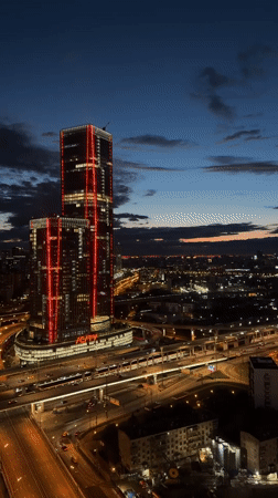 Evening cityscape observed in Khimki featuring illuminated skyscraper