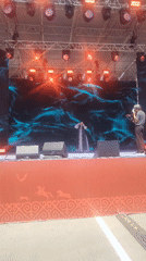 Traditional Kazakh vocal performance on an outdoor stage in Astana