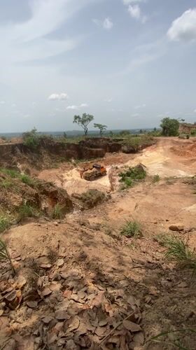 Workers load sand into truck at Nigerian excavation site