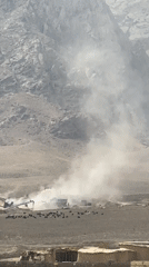 Dust devils and decorated trucks on a Balochistan road