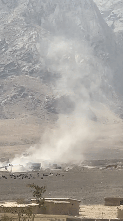 Dust devils and decorated trucks on a Balochistan road