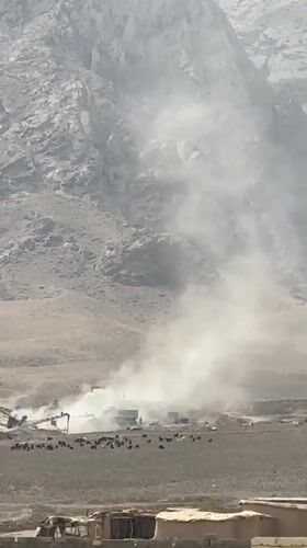 Dust devils and decorated trucks on a Balochistan road