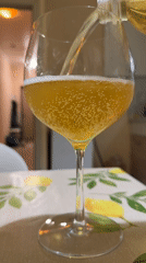 Golden beverage poured into stemmed glass in Tobolsk