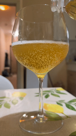 Golden beverage poured into stemmed glass in Tobolsk