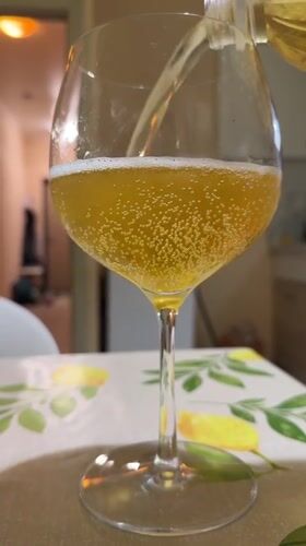 Golden beverage poured into stemmed glass in Tobolsk