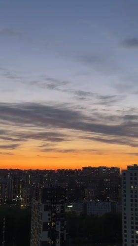 Dusk settles over Kudrovo cityscape with illuminated buildings