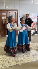 Folk dancers perform in traditional costumes in Elovo hallway