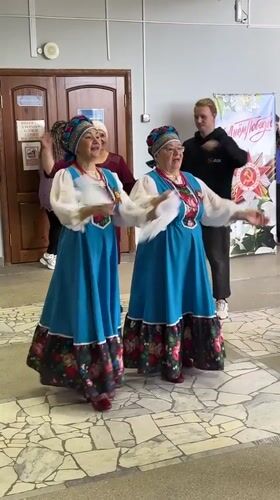Folk dancers perform in traditional costumes in Elovo hallway