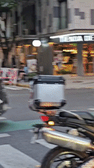 Woman cycles through Buenos Aires streets amid emergency vehicles