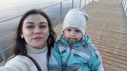 Mother and child spend afternoon on pier in Chaikovsky
