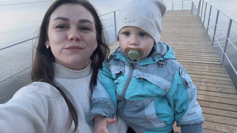 Mother and child spend afternoon on pier in Chaikovsky
