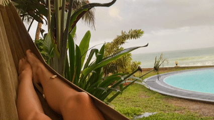 Person relaxes in hammock amid tropical foliage in Sri Lanka
