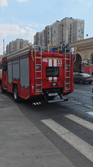 Fire trucks block city street crossing amid emergency response