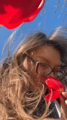 Woman photographed with red tulips in Aksay, Kazakhstan