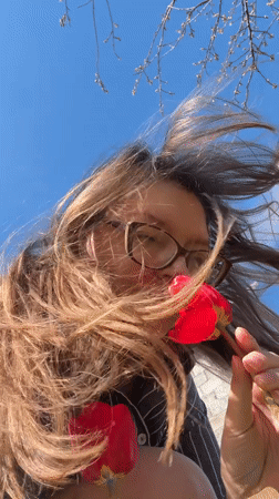 Woman photographed with red tulips in Aksay, Kazakhstan