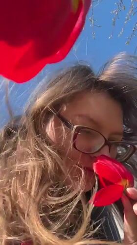 Woman photographed with red tulips in Aksay, Kazakhstan
