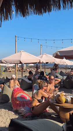 Beach club scene in North Kuta with umbrellas and beanbags