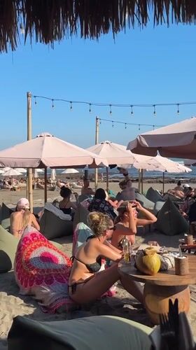 Beach club scene in North Kuta with umbrellas and beanbags