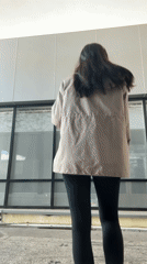 Woman drinks coffee outside modern building in Sochi