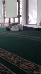Inside a green-carpeted mosque in Jember during morning prayers