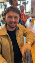 Man uses phone to buy beer at busy Paris bar