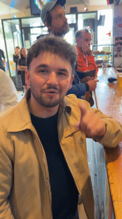 Man uses phone to buy beer at busy Paris bar