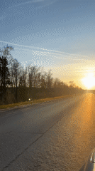 Road sunset captured on video shows orange-blue sky gradient
