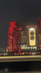Moving vehicle captures nighttime Macau-Zhuhai skyline footage