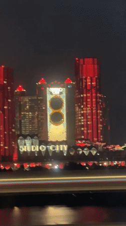Moving vehicle captures nighttime Macau-Zhuhai skyline footage