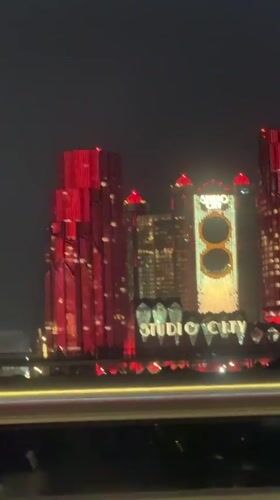 Moving vehicle captures nighttime Macau-Zhuhai skyline footage