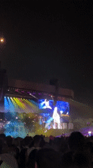 Nighttime concert draws dense crowd with large screen performer display