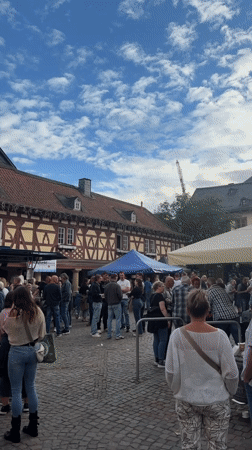 Outdoor gathering on cobblestone street in Meisenheim, Germany