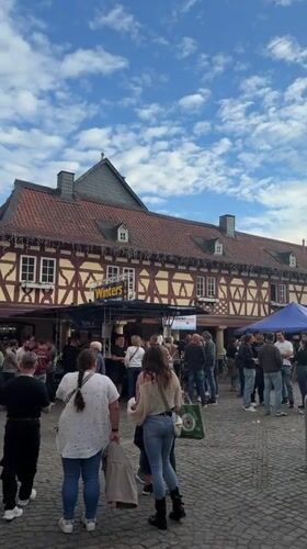 Outdoor gathering on cobblestone street in Meisenheim, Germany