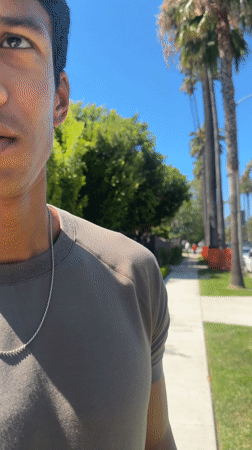 Man films video content on Beverly Hills residential street