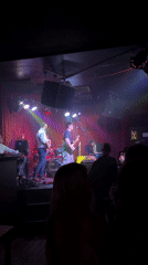 Live band performs in colorfully lit London venue