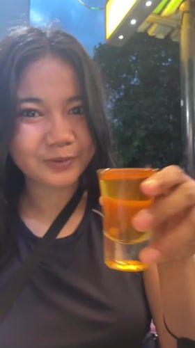 Woman samples herbal remedies at Jakarta convenience store